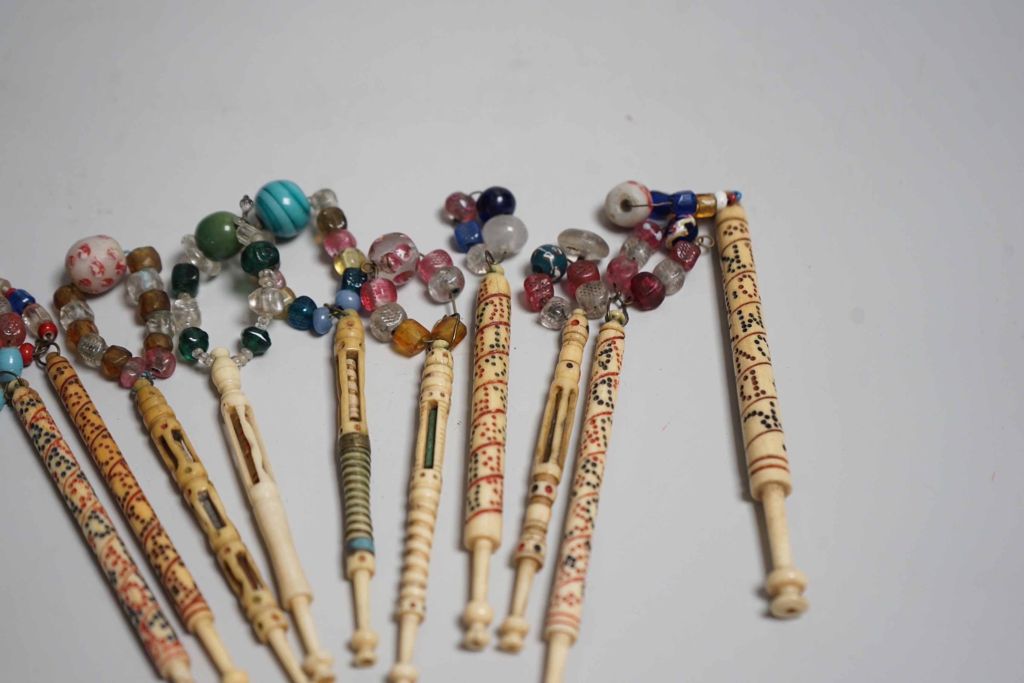 Five 19th century unusual reticulated bone lace bobbins with diagonal messages and five other ornately carved bobbins (10)